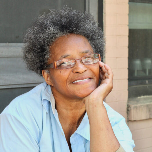 older lady smiling on her porch