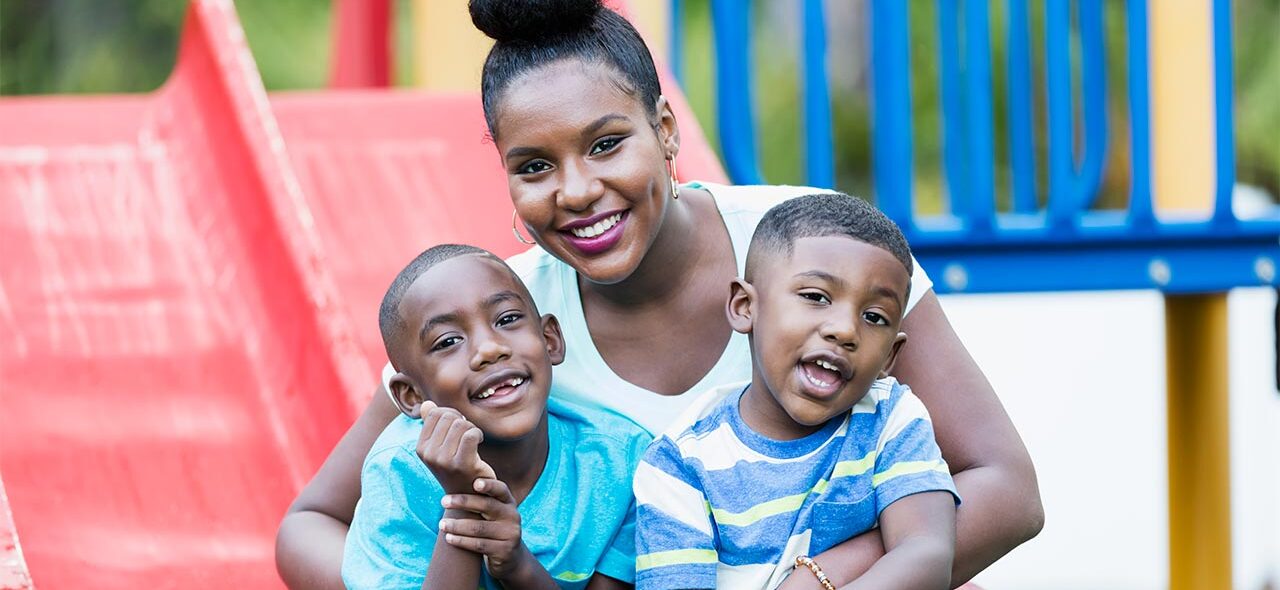 Mother with two sons on a playground slide