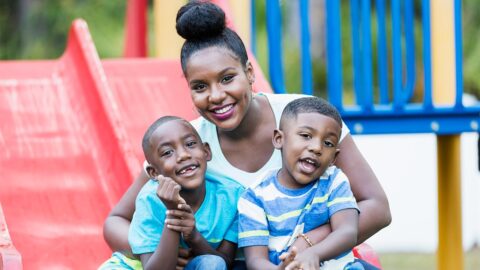 Mother with two sons on a playground slide