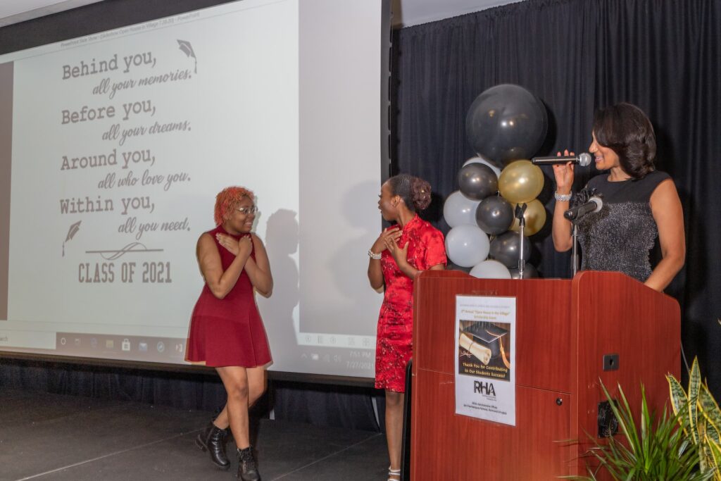 2021 "Open House in the Village" scholarship ceremony - girls happy on stage