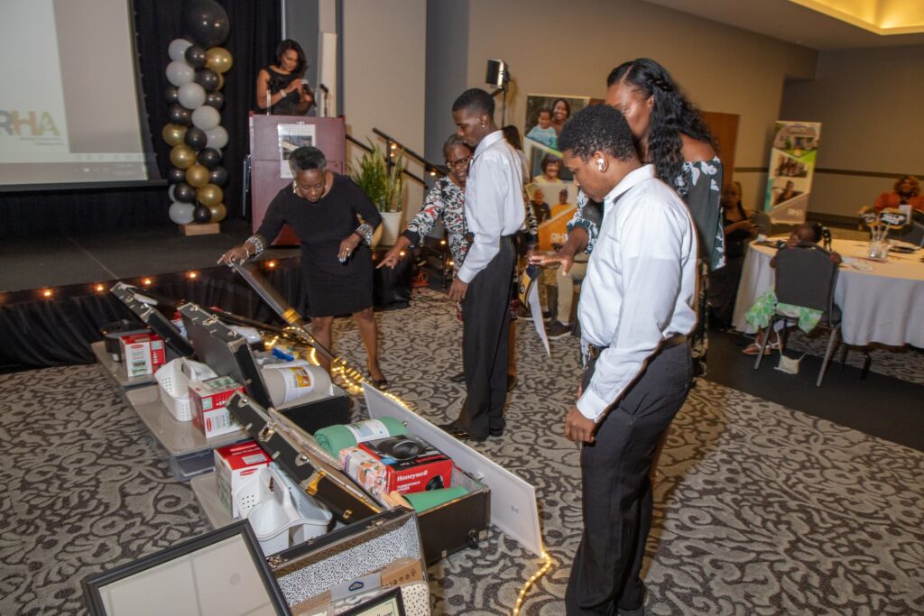2021 "Open House in the Village" scholarship ceremony - recipients looking at gifts