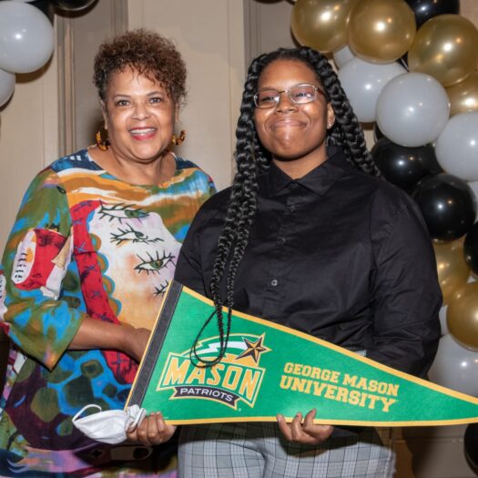 2020 "Open House in the Village" scholarship ceremony - recipient posing with mother and George Mason University banner