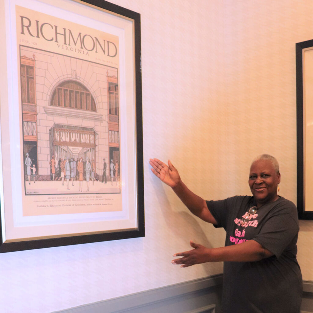 Cora Hayes standing beside a picture of historic Richmond