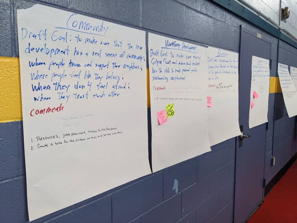 Handwritten text of community goals, taped to a wall.