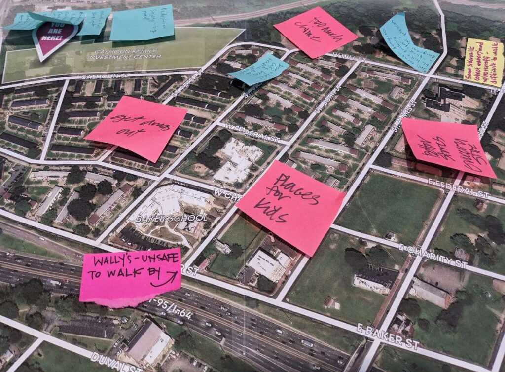 A close up of a neighborhood map with sticky notes attached
