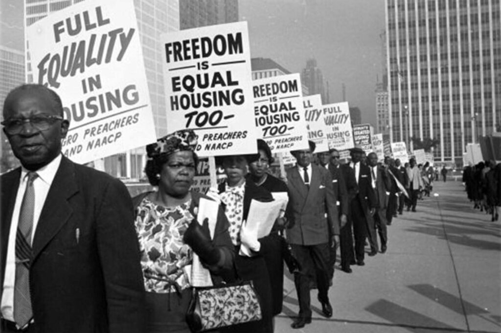 Historic photo of protesters advocating for equal housing