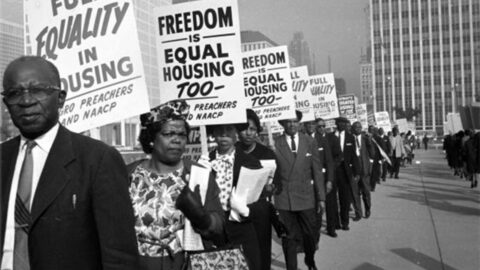 Historic photo of protesters advocating for equal housing
