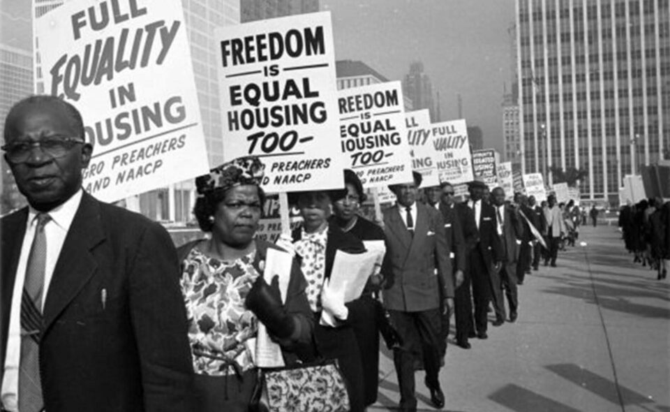 Historic photo of protesters advocating for equal housing