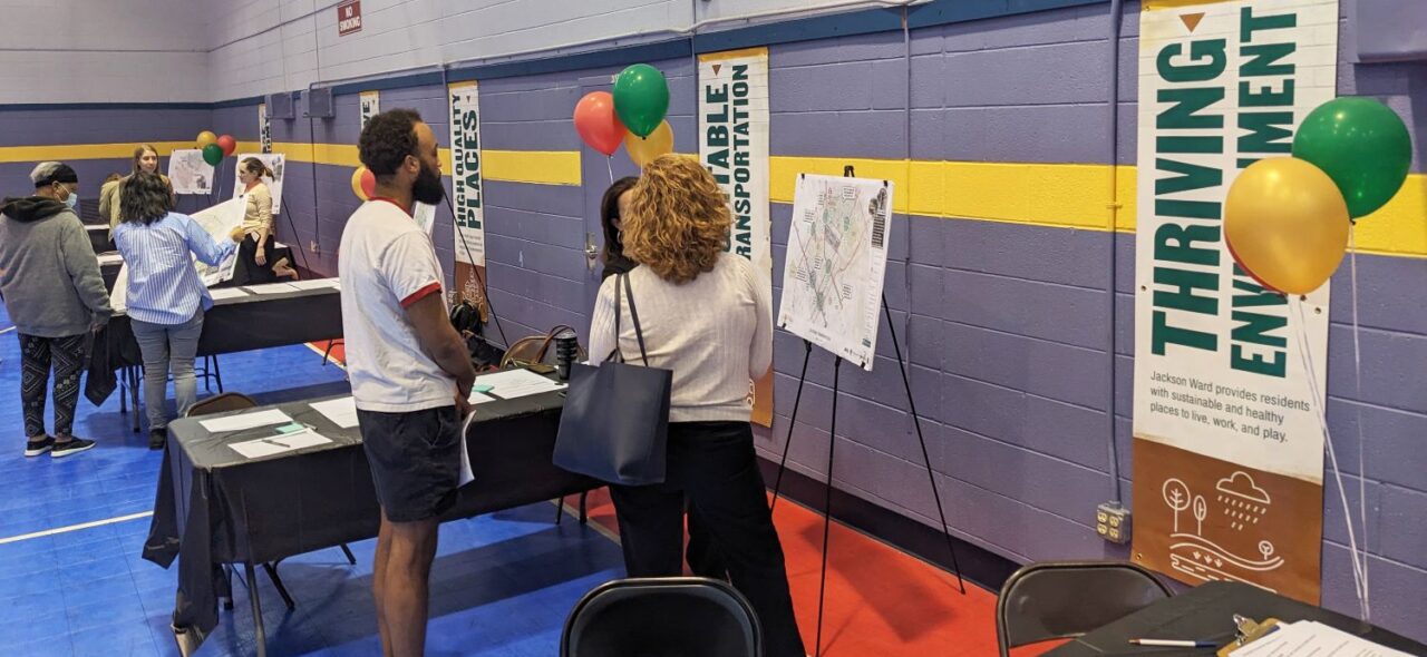 People having a discussion in front of informative poster boards