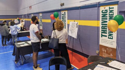 People having a discussion in front of informative poster boards