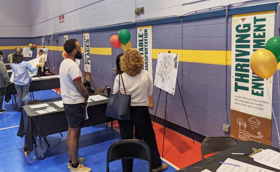 People having a discussion in front of informative poster boards