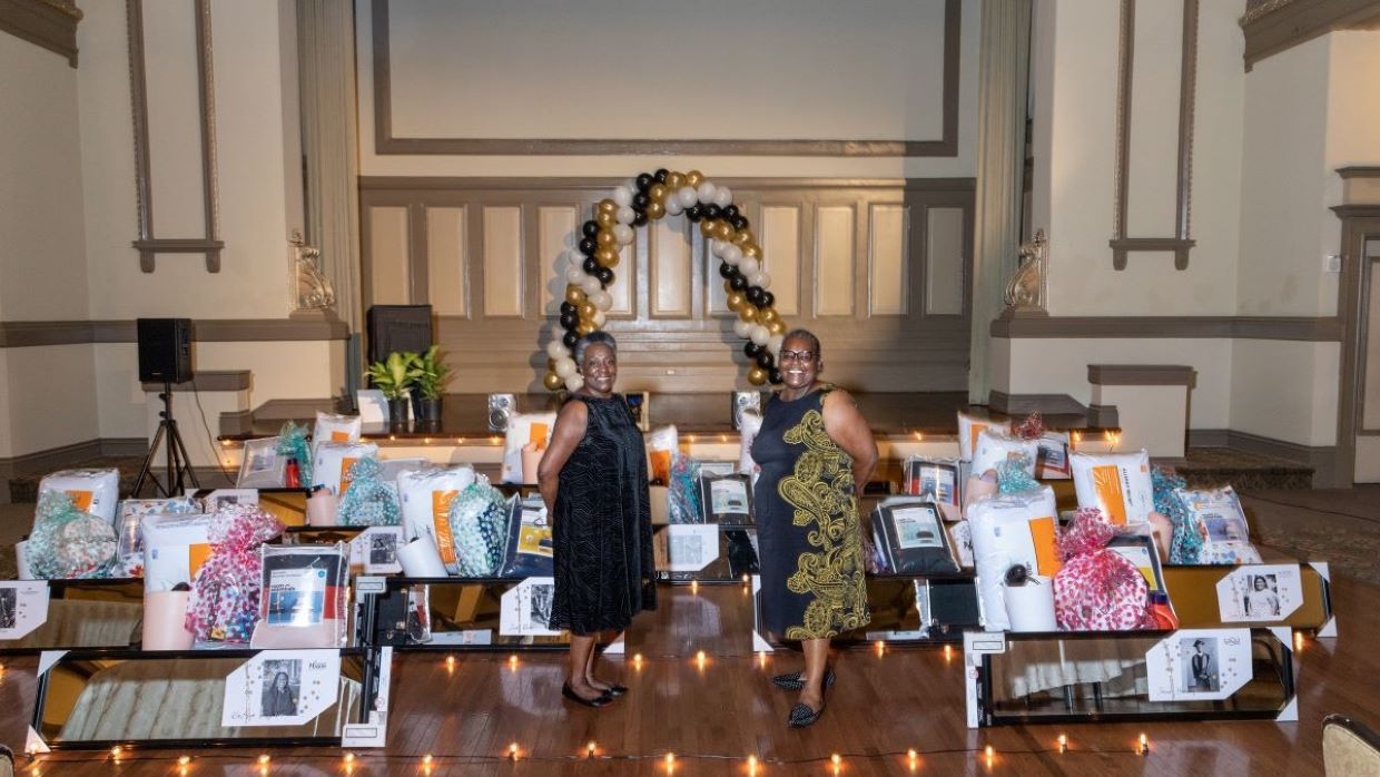 2020 presenters posing in front of gift display