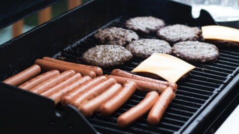 A grill with hotdogs and hamburgers