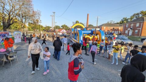 A crowd of residents and community members celebrating at the Jackson Ward Community Plan final event