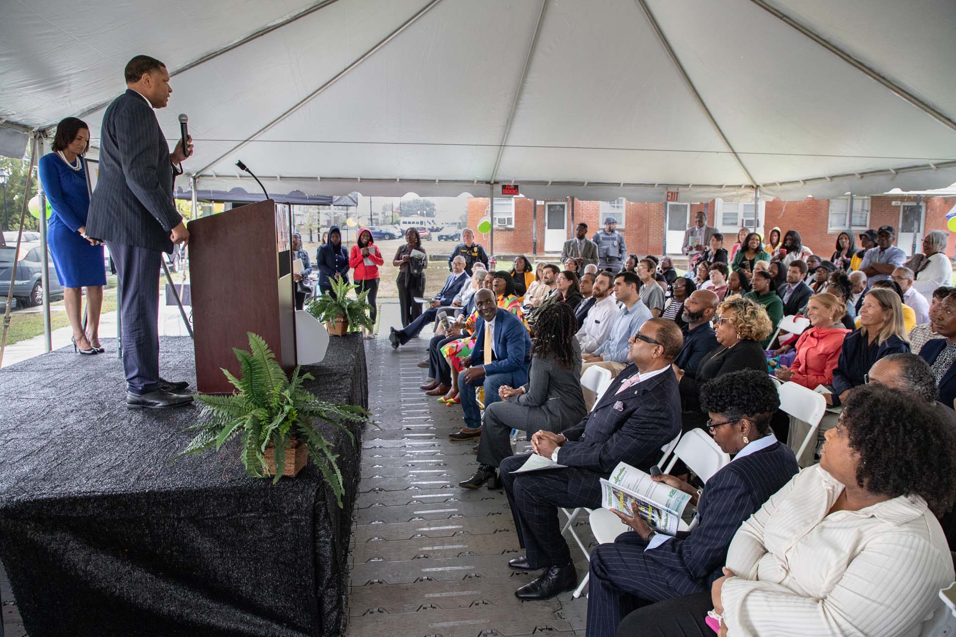 RRHA CEO Stephen Nesmith speaking to a crowd in an outdoor pavilion